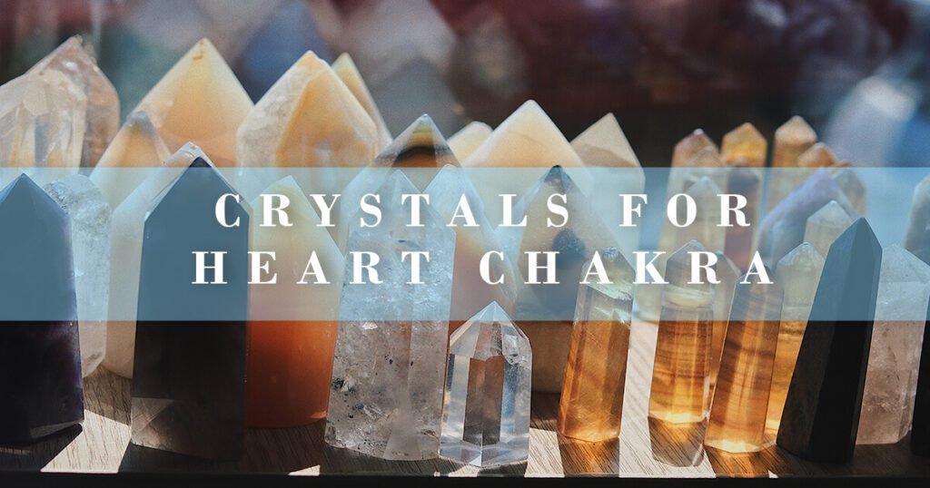 how to heal heart chakra with crystals - pointed crystals standing on a desk with sun light bursting through them